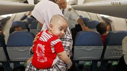 Iraqi refugees board a plane Sunday at Damascus airport in Syria. Iraq flew hundreds of its citizens out of Damascus to escape the fighting in Syria.