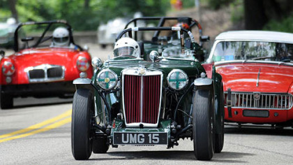 MGs racing in the Marque of the Year race at the 30th annual Vintage Grand Prix charge up West Circuit Road in Schenley Park on Sunday.