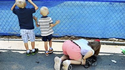 People from the community try to get a look at the site in which the statue of former Penn State football coach Joe Paterno stood sits empty after it was removed by workers outside Beaver Stadium on Sunday in State College. Penn State's president, Rodney Erickson, made the decision Sunday to remove the statue in the wake of the child sex scandal of former assistant football coach Jerry Sandusky. It's believed that Paterno had detailed knowledge of Jerry Sandusky sexually abusing children before and after Mr. Sandusky retired from coaching at Penn State.