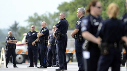 State College and Penn State police form a line in front of Beaver Stadium moments after the statue of former Penn State football coach Joe Paterno was removed Sunday. The famed statue of Paterno was taken down from outside the Penn State football stadium Sunday, eliminating a key piece of the iconography surrounding the once-sainted football coach accused of burying child sex abuse allegations against a retired assistant.