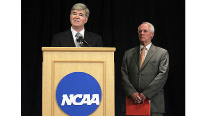 NCAA President Mark Emmert, left, announces penalties against Penn State  as Ed Ray, NCAA Executive Committee chair looks on.