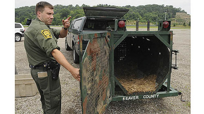 State wildlife conservation Officer Matt Kramer shows a bear trap that had been set Monday near the Pittsburgh Mills mall in Frazer.