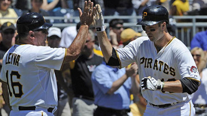 Pirates Neil Walker is congratulated by third base coach Nick Leyva after hitting a home run in the first inning against the Cubs Wednesday afternoon.