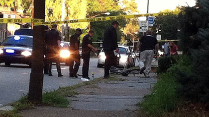 Pittsburgh police officers look over the scene where a bicyclist died early Wednesday morning after being struck by a car in Point Breeze.