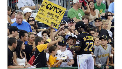 Pirates' Andrew McCutchen signs autographs before the start of the game against the Cubs Tuesday night.