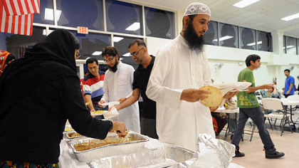 Muslim men and women break their Ramadan fasts for the evening at the Muslim Community Center in Monroeville.