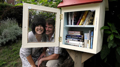 Lisa Ciccarelli and her husband Rick McGee with their Word House on Biddle Avenue in Regent Square. The little free lending library is part of a nationwide movement, and the rules are simple: take a book, leave a book.