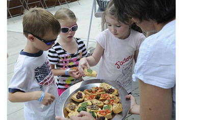 Visitors to the Children's Museum on the North Side are treated to Chef Angelo Galioto's bruschetta, which he put together in an outdoors demo in Buhl Community Park.