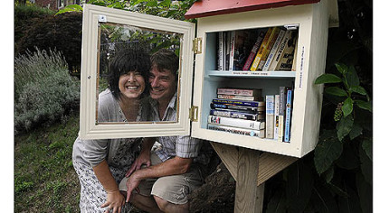 Lisa Ciccarelli and her husband, Rick McGee, with their Word House on Biddle Avenue in Regent Square. The Word House is a small free lending library where anyone can take a book after leaving one. The idea is part of a national trend, as found at www.freelibrary.org.