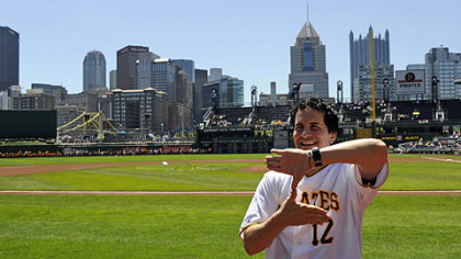 Hal Sparks, center, the father of the Zoltan sign, poses Wednesday with Neil Walker and Rod Barajas, right, in the Pirates dugout at PNC Park.