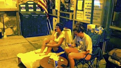 Sandy Wagner and her daughter, Emily, 17, of Bethel Park, camp out at the permit office in South Park. The two were first in line to reserve a park building called the Cottage for Emily's graduation party next year.