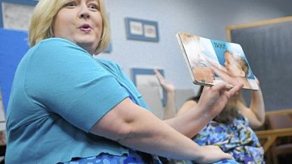 Brentwood librarian Tracy O'Neill reads to babies and parents last Thursday. "It's never too early to introduce babies to a relationship with words, books and information," she says.