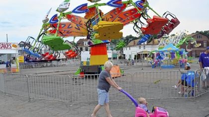 Dolly Moore of McKees Rocks pushes her granddaughter, Sonni Spadacci, through the annual Stowe Volunteer Fire Department summer carnival two weeks ago.