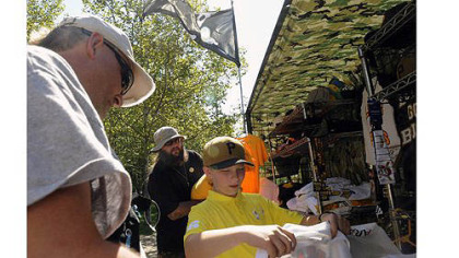 John Marcus of Morgantown, W.Va., helps his son Luke, 11, buy a T-shirt on Wednesday from Frank Kandcer of VIP Vending, outside PNC Park.