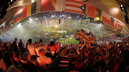Flags of various countries hang in the foreground as spectators wave the national flag of Great Britain during the Opening Ceremony at the 2012 Summer Olympics, Saturday, July 28, 2012, in London.