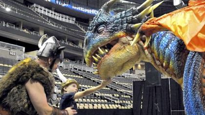 Sig the Viking shows Caden Suba, 8, of Franklin Park to find the "soft spot" of baby dragon Nadder at the How to train your dragon Live Spectacular preview July 26 at Consol Energy Center.