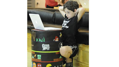 Kendall Barker, above, works on creating an online game during the school summer program at Elizabeth Forward Middle School.