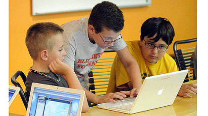 From left, Ethan Thoma, Carson Tokar and Broc Balta work on creating an online game.