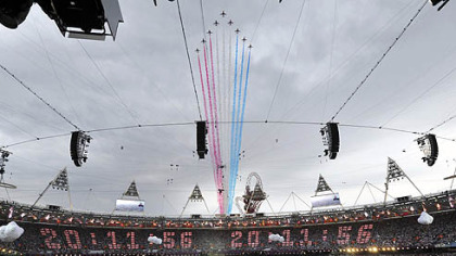 The Red Arrows squad makes a flyover ahead of the Opening Ceremony above the 2012 Olympic Summer Games at the Olympic Stadium, London, today.