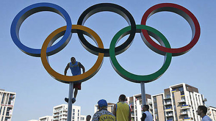 Ukrainian boxer Alexander Usik climbs the Olympic rings for photos at the Athletes' Village at the Olympic Park. The opening ceremonies for the 2012 London Olympics will be held today.