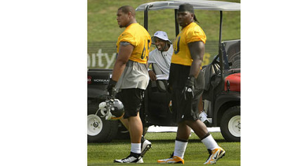 Steelers running backs coach Kirby Wilson shares a laugh with players at training camp Thursday at Saint Vincent College in Latrobe.