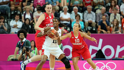 Swin Cash (#11) of United States fights for possession of the ball against Luca Ivankovic (#14) and Iva Ciglar (#10) of Croatia.