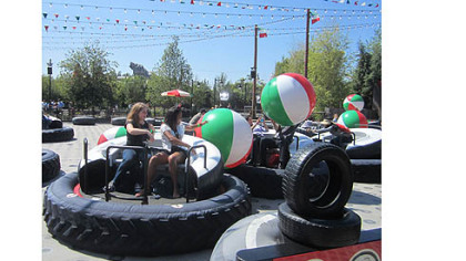At Luigi's Flying Tires at Disney California Adventure, riders sit atop giant tires and angle to grab giant beach balls to toss at other tire jockeys.