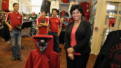 Priya Narasimhan, associate professor at Carnegie Mellon University, with ScotBot, the robot that she and students developed so that it can take inventory of the Carnegie Mellon bookstore in University Center on campus. Graduate students who assisted are, from left, Jon Francis, Kunal Mankodiya and Amit Knishnan.
