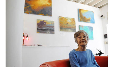Artist Donna Hollen Bolmgren in front of work from her show "Journey."