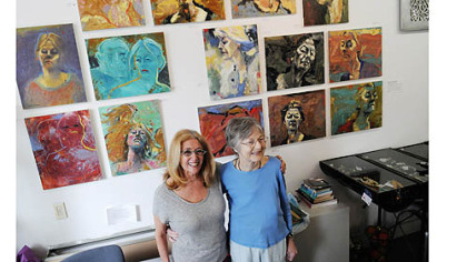 Artist Donna Hollen Bolmgren, right, in front of work from her show "Journey ... Most Recent Works," with longtime friend and owner of Gallerie Chiz in Shadyside, Ellen Chisdes Neuberg.