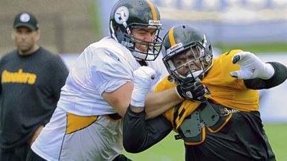 No. 1 pick David DeCastro, left, battles Al Woods Saturday afternoon -- the first day players were in pads.