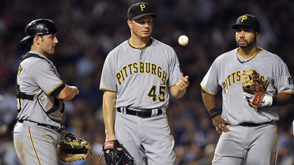 The Pirates' Michael McKenry, left, and Pedro Alvarez, right, watch as pitcher Erik Bedard tosses the ball in the air after giving up a three-run home run to the Cubs' Anthony Rizzo during the fifth inning Monday in Chicago.