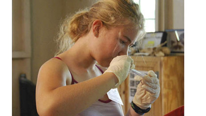 Rena Hegyi, a camper from Kentucky who will attend Dartmouth in the fall, studies the effects of carnivorous juices from pitcher plants.