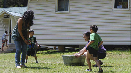 The National Youth Science Camp has been held at Camp Pocahontas, a 4H site, since 1963. Even playtime involves science as Shana Rose sprays friends with a