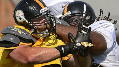Defensive end Brett Keisel battles Willie Colon during afternoon workouts at training camp.