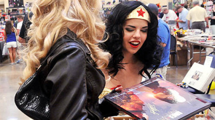 Julia Devine, aka Wonder Woman, from North Huntingdon reacts to a Romeo and Juliet book created by comic legend Stan Lee at one of the booths at the Steel City Con.