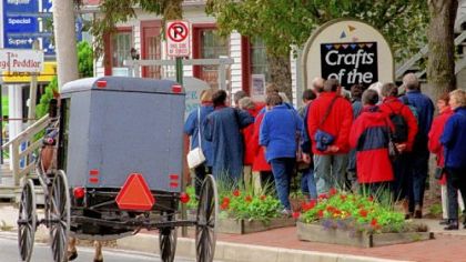 A group of tourists walk along Old Philadelphia Pike in Intercourse, Pa. Tourists come to Lancaster County by the bus loads year round to see the Amish and to shop at the local craft stores around the county.