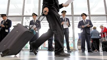 United Airlines pilots pass out leaflets to passengers at O'Hare International Airport on May 7 to get their point across United's outsourcing of U.S. jobs.