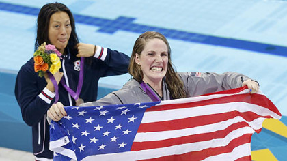 United States gold medalist Missy Franklin holds a national flag at a medal ceremony with Japan's silver medalist Aya Terakawa after the women's 200-meter freestyle swimming semifinal Monday.