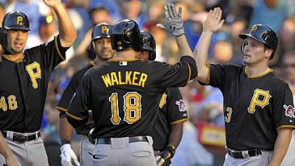 Pittsburgh Pirates'' Garrett Jones and Travis Snider right, congratulate Neil Walker after his grand slam against the Chicago Cubs.