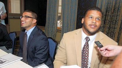 Pitt defensive lineman Aaron Donald, right, and safety Jarred Holley, left, answer questions from the media at the Big East Conference media day.