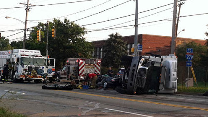 Three people were trapped when a truck overturned onto a car in Ross early Wednesday morning.
