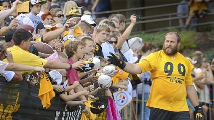 Steelers defensive lineman Brett Keisel waves to the fans as he makes his way to the field before the start of workouts Friday at Steelers training camp at Saint Vincent College near Latrobe.