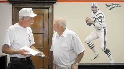 Larry Bruno Foundation board members Ken Thomas, left, and Ed Derose discuss logistics for Saturday's events at the Hall of Achievement Sports Museum in the Carnegie Free Library in Beaver Falls.