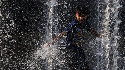Seven-year-old Taylor Edmonds of Allentown plays in the fountain at PPG Plaza on Thursday.