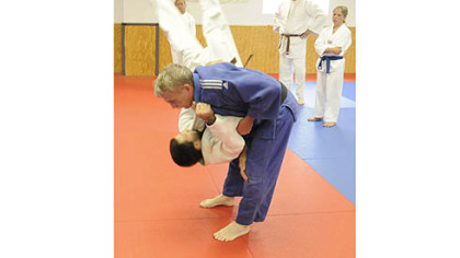 Judo instructor Chuck Schmidt throws Mark Langdon on the ground during practice today at Kim's Martial Arts & Fitness in Brentwood.