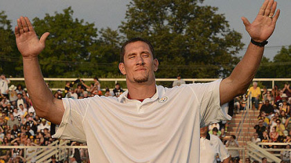 Aaron Smith waves to fans after he was introduced at Latrobe Memorial Stadium on Friday night, where he joined three other players to retire as a Steeler.