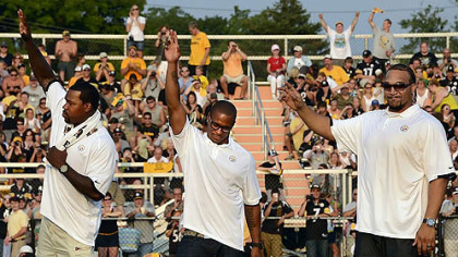 From left, Joey Porter, Willie Parker and Marvel Smith wave to the crowd Friday night at Latrobe Stadium as they retire as Steelers.