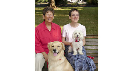 Sister Pat Montini, left, with her golden retriever Luca and  Sister Sharon Costello with Buster, the Maltese.