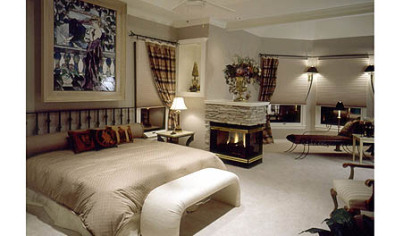 With today's floor plans having rooms and functions flowing into one another, there often is no private space left as a retreat from the activity of the family. Here is a solution == a master bedroom retreat that includes a sleeping area and a bay-windowed sitting room separated by a three-sided gas fireplace that creates ambience at the push of a button. Both rooms are distinguished by trayed ceilings.